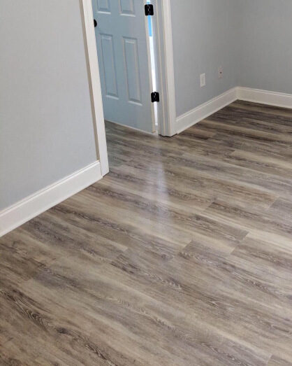 Room with gray walls and wood-look plank flooring
