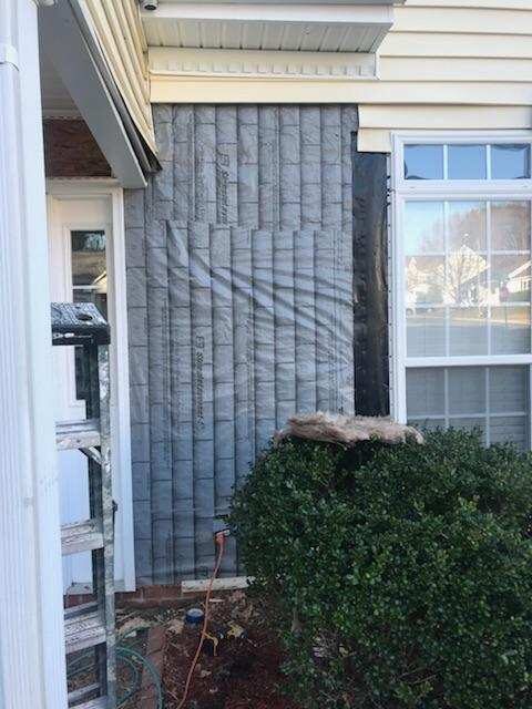 Siding repair beside a window