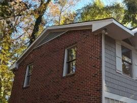 Brick home with new gable siding