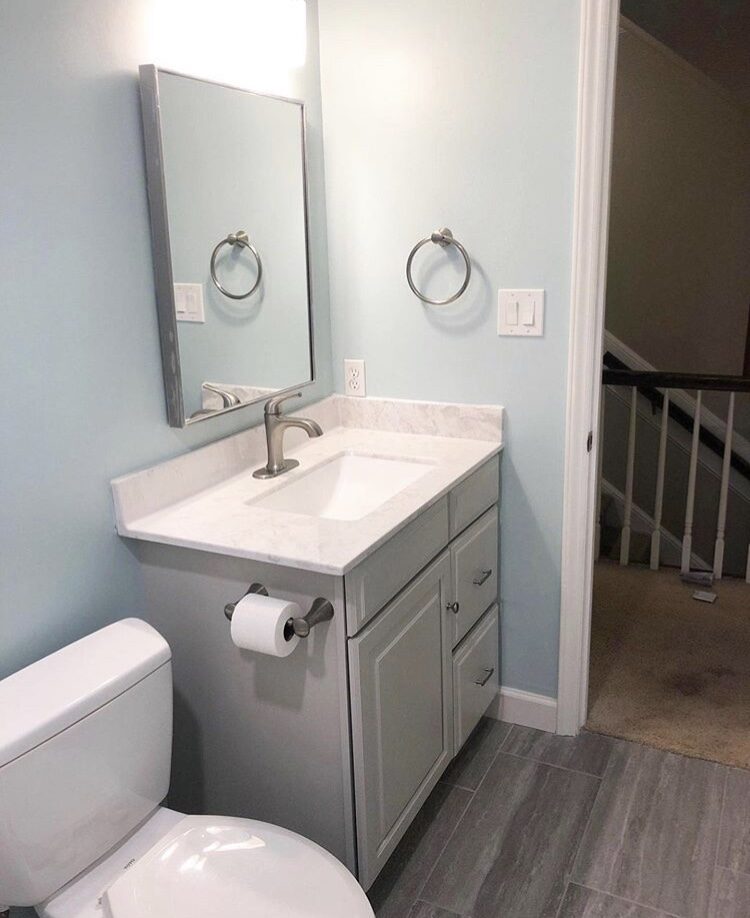 Bathroom with gray vanity and light blue walls