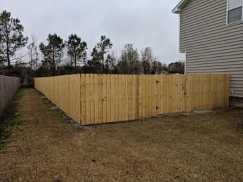Wood privacy fence along a yard