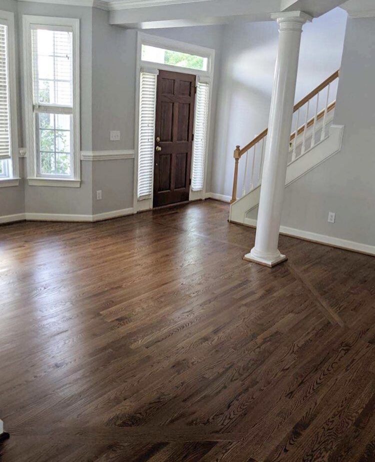 Entry foyer with staircase, column and hardwood floors