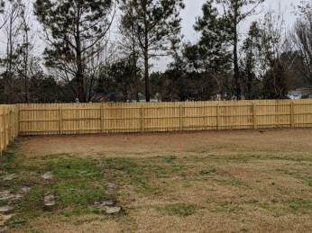 Wood privacy fence around a backyard