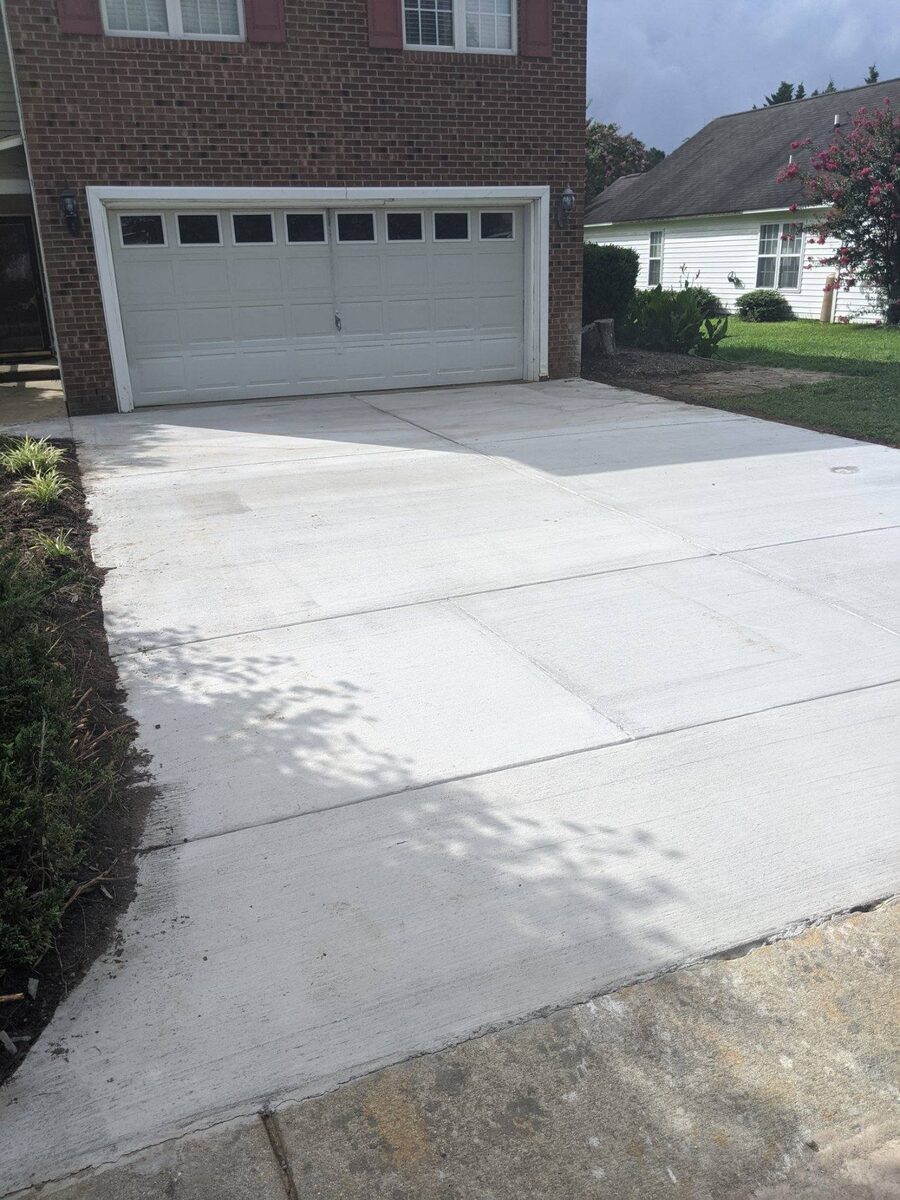 New concrete driveway in front of a garage