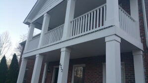 Two-story porch with white columns and railing